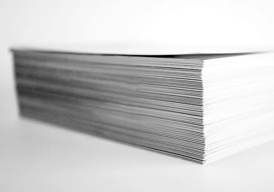 A tall stack of printed A4 paper