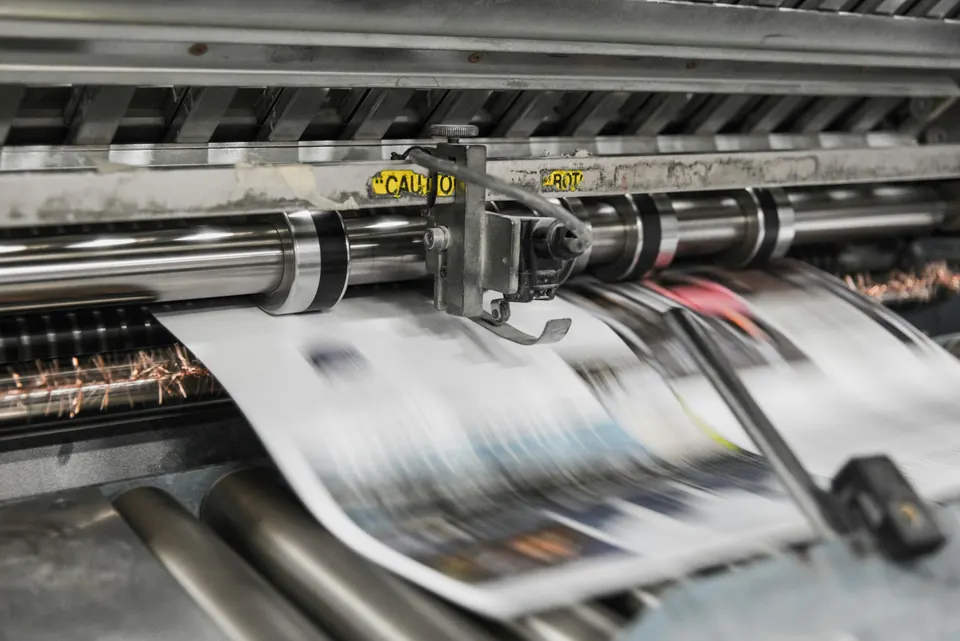 Freshly printed sheets running through a printing machine